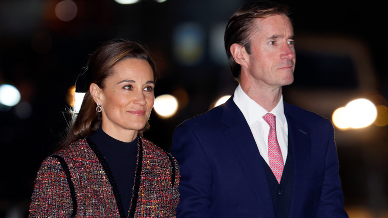 Pippa Middleton wearing a coat and James Matthews wearing a suit