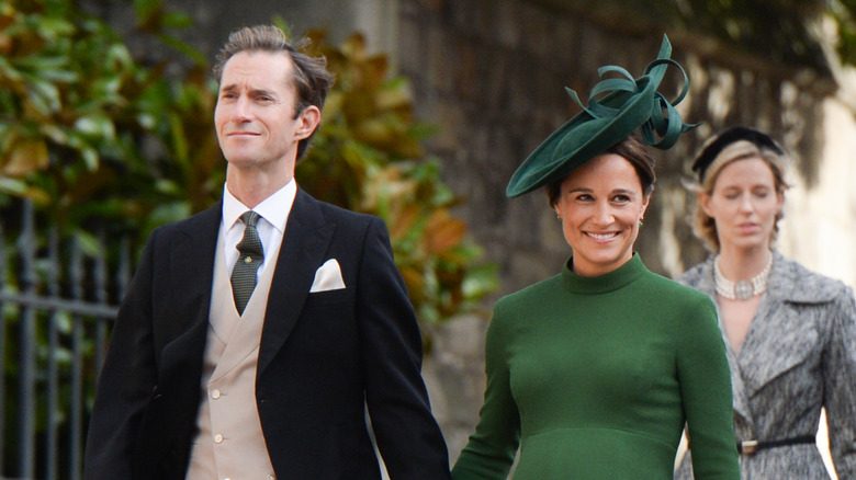 James Matthews wearing a suit and Pippa Middleton wearing a green dress and matching hat