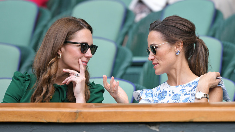 Kate Middleton and Pippa Middleton speaking together at Wimbledon