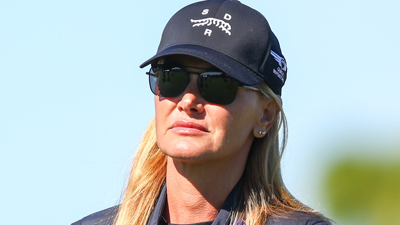 Vanessa Trump frowning while wearing a baseball cap and sunglasses