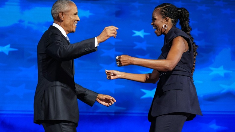 Barack Obama and Michelle Obama going in for a huge