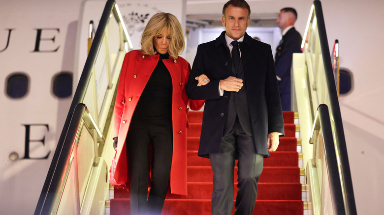 Emmanuel Macron and Brigitte Macron deplaning