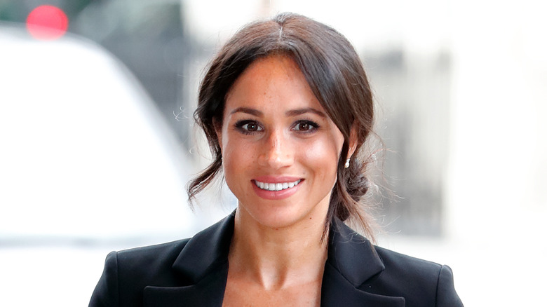 Meghan Markle smiles for the camera. 