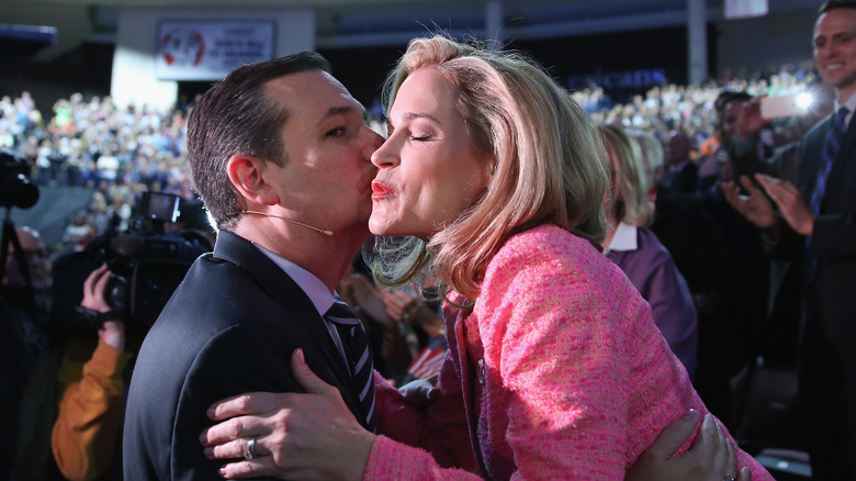 Ted Cruz kissing Heidi Cruz surrounded by camera crew and crowds