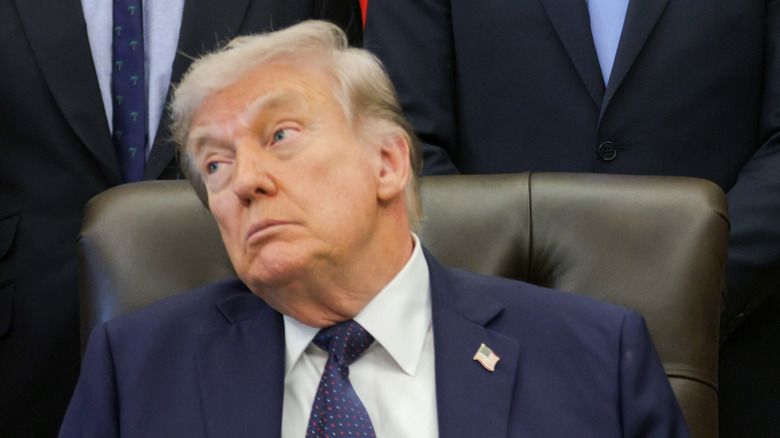 Donald Trump sitting at his desk in the Oval Office.