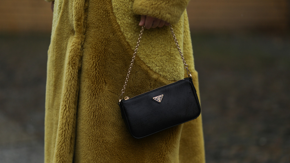 Woman holding Black Prada bag