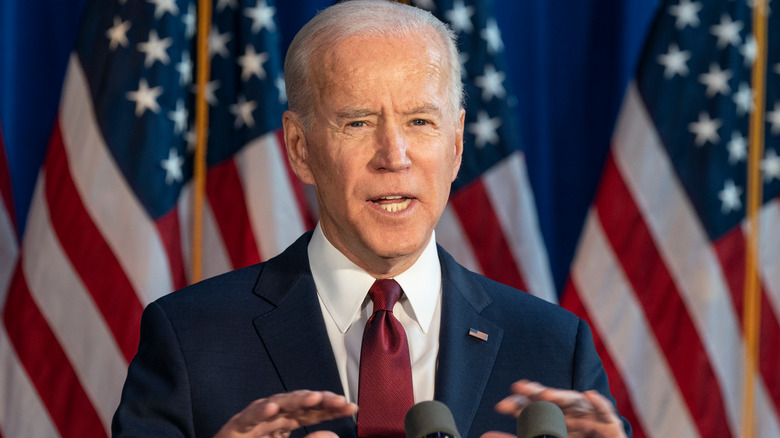 Joe Biden in front of American flags