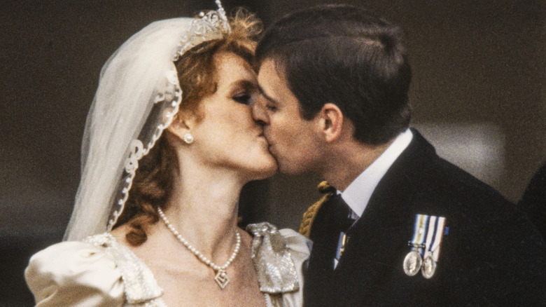 Sarah Ferguson and then-Prince Andrew kiss on the palace balcony