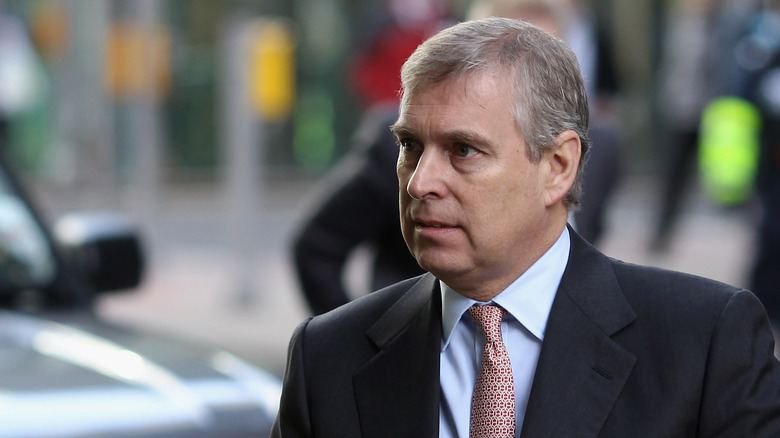 Prince Andrew wearing a formal tux and a serious expression