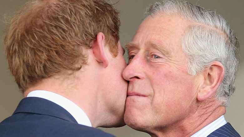 Charles kissing Harry on cheek