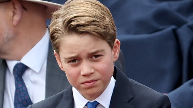 Prince George frowning in a suit