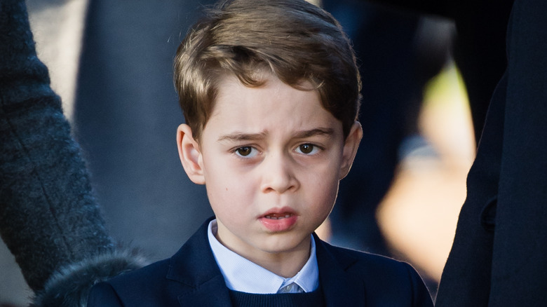 Prince George of Cambridge stares ahead while attending the Christmas Day Church service at Church of St Mary Magdalene on the Sandringham estate on December 25, 2019 in King's Lynn, United Kingdom (2019)