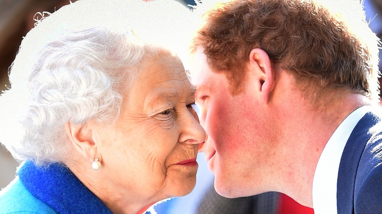 Prince Harry whispering to Queen Elizabeth II