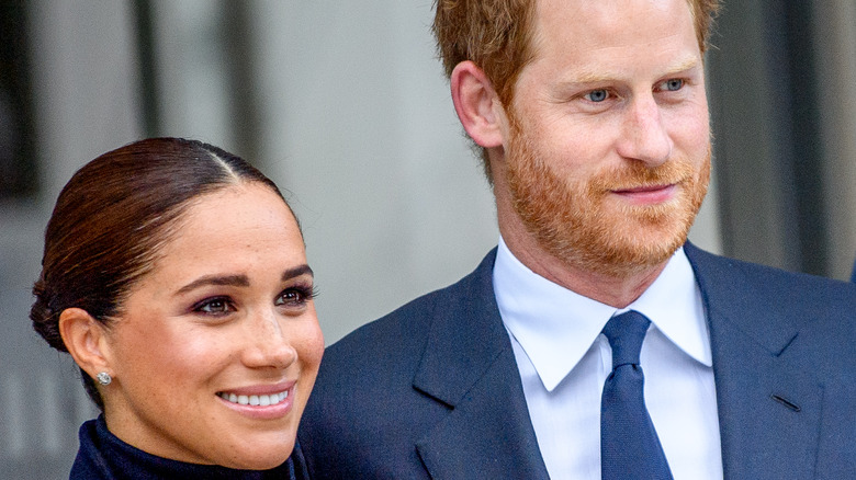 Prince Harry and Meghan Markle smiling at an event