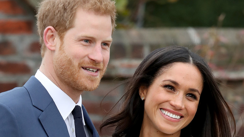 Prince Harry and Meghan Markle smiling