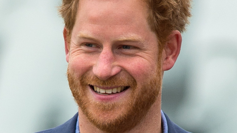 Prince Harry smiles at an event 