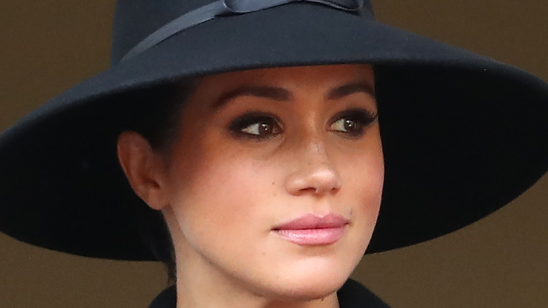 Meghan Markle looks pensive in a hat