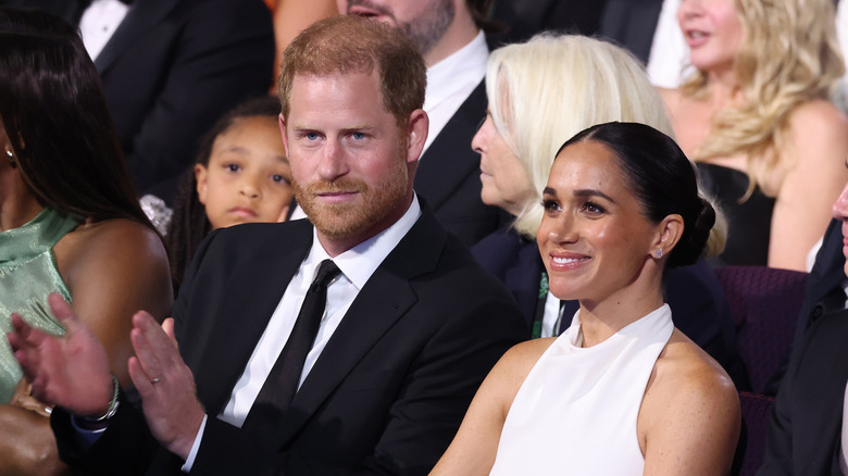 Prince Harry and Meghan Markle sitting at an event