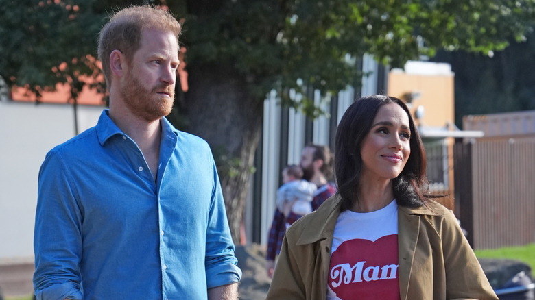 Prince Harry and Meghan Markle standing next to each other
