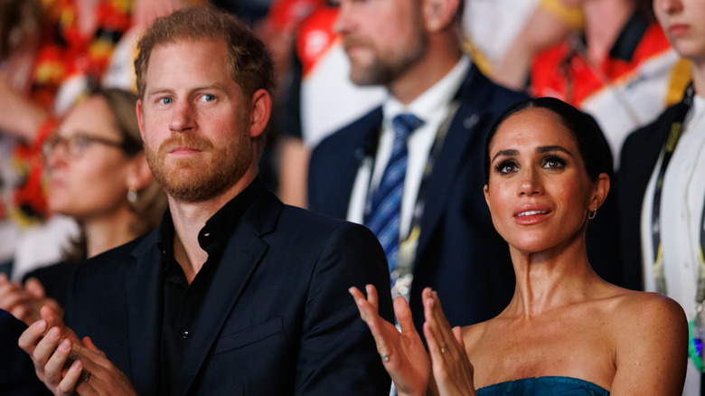 Prince Harry and Meghan Markle clap