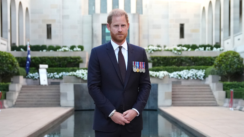 Prince Harry wearing a suit with military medals