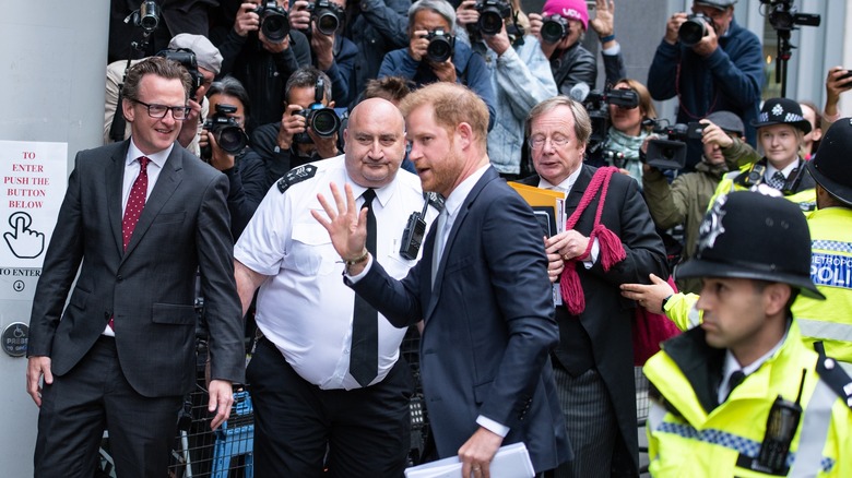 Prince Harry surrounded by police and security