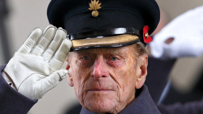 Uniformed Prince Philip saluting