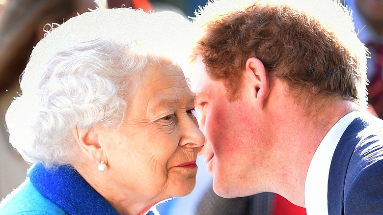 Prince Harry kissing his grandmother Queen Elizabeth on the cheek