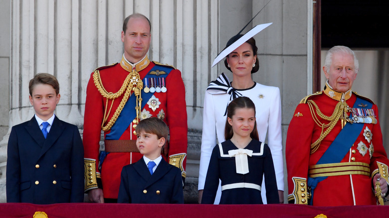 Members of the British royal family posing together in their finery on the balcony at Buckingam Palace