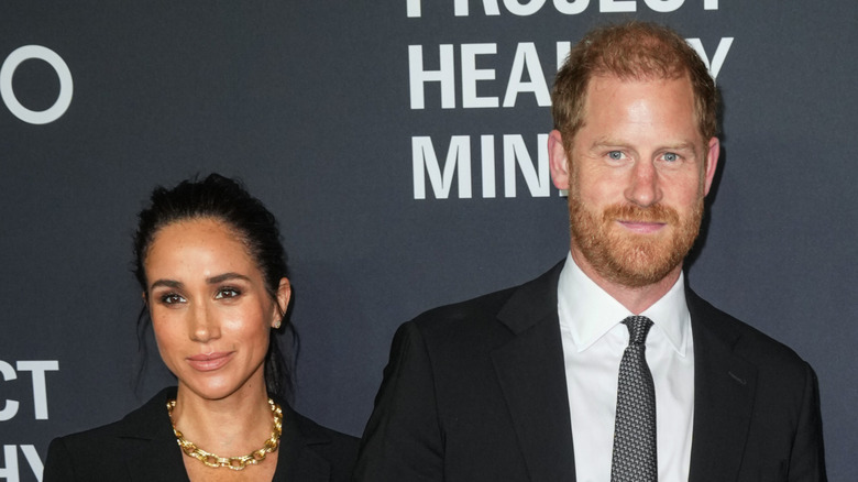 Prince Harry and Meghan Markle posing on the red carpet