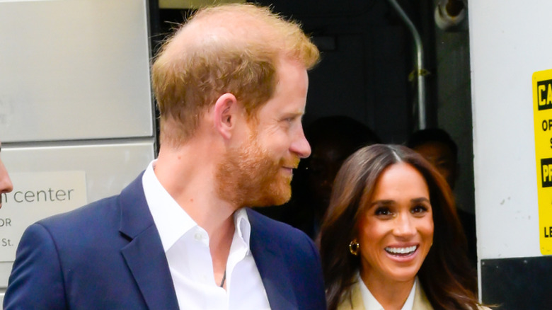 Prince Harry and Meghan Markle exiting doorway