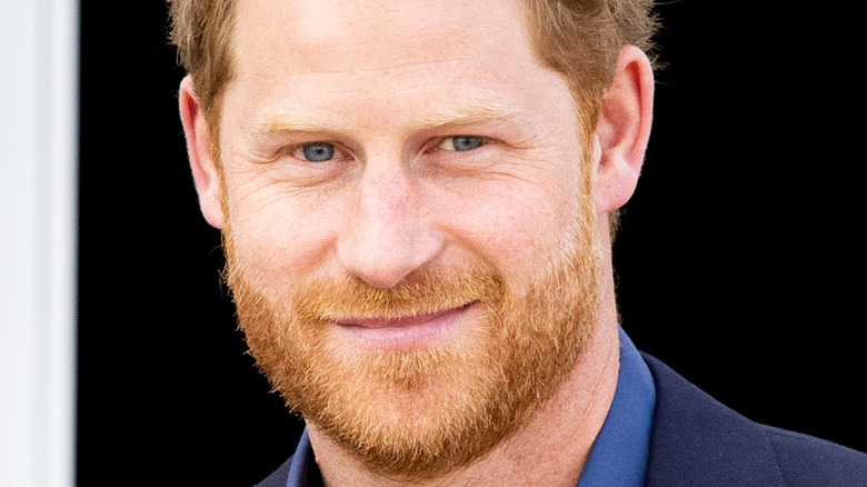 Prince Harry smiling in a suit