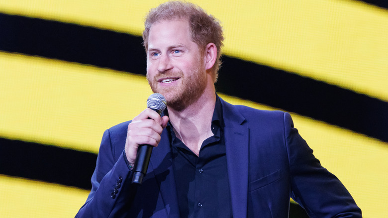 Prince Harry smiling with microphone