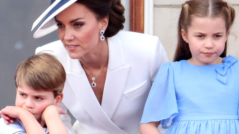 Prince Louis looking sulky with Kate Middleton and Princess Charlotte