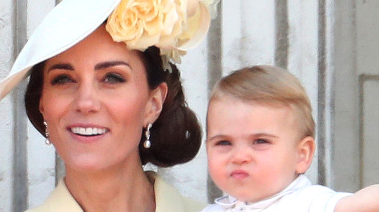 Prince Louis shows off in his mother's arms
