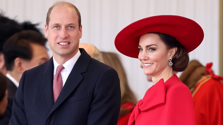 Prince William and Kate smiling at onlookers
