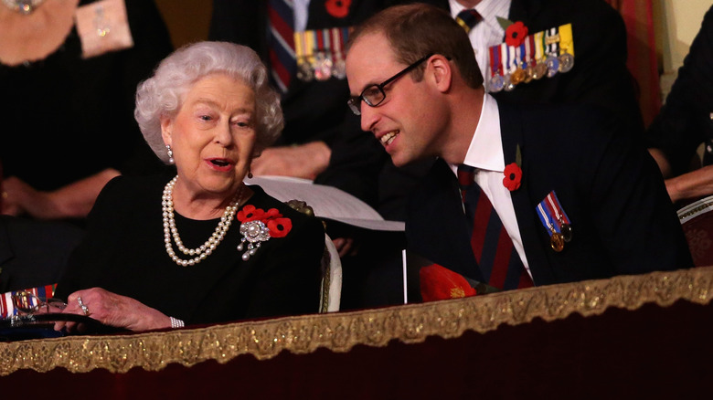Prince William and Queen Elizabeth II having a chat while sitting on a balcony together