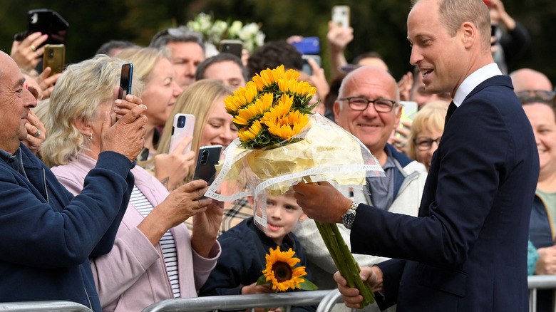 Prince William takes flowers at Windsor Castle