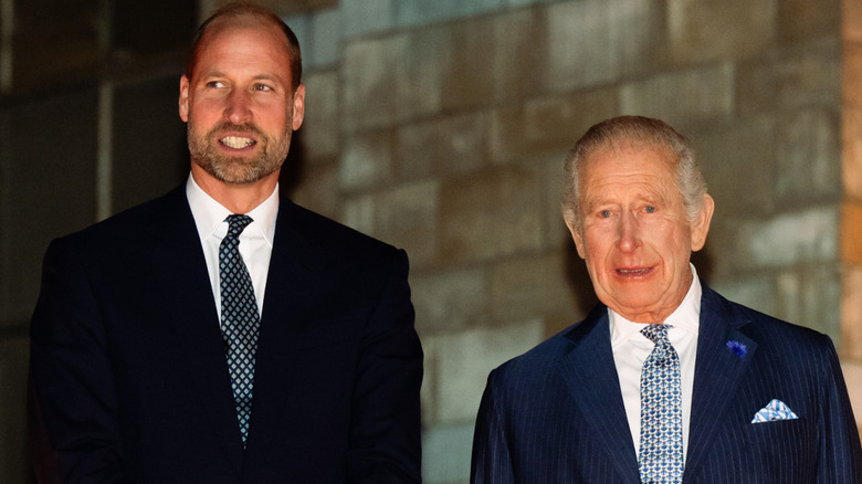 Prince William standing next to King Charles III