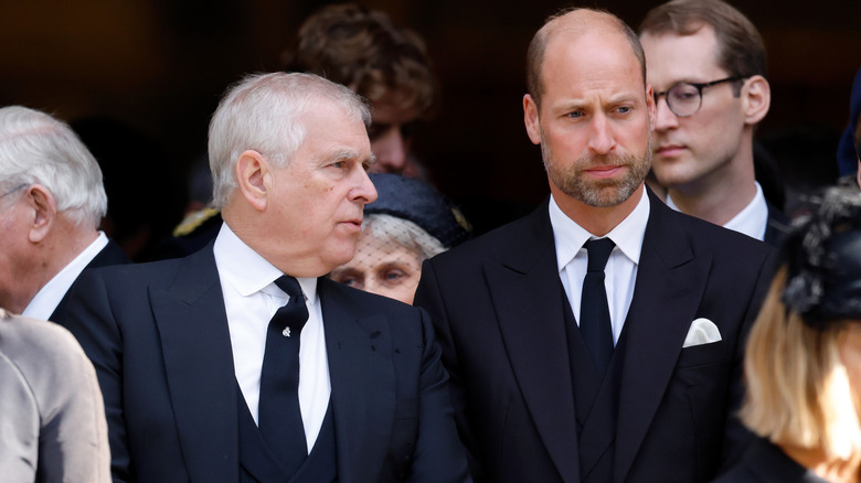 William, Prince of Wales looking away while Andrew Mountbatten-Windsor talks to him