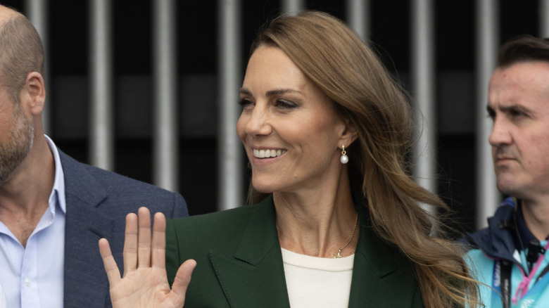 A smiling Princess Catherine waving at someone