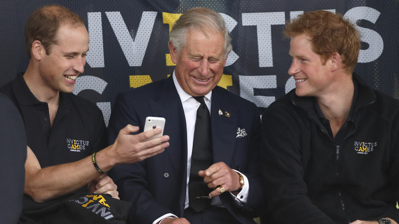 Prince William, King Charles, and Prince Harry laughing