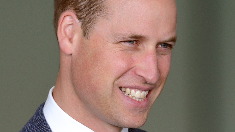 Prince William smiles at an event. 