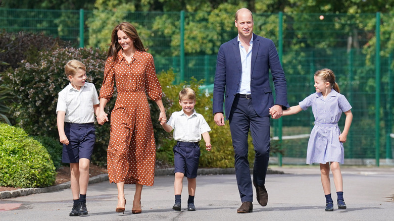 Prince William and Princess Catherine walking with children