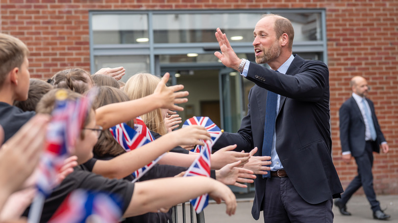 Prince William greeted by school-aged children