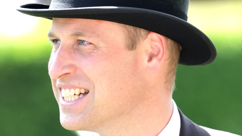 Prince William smiling in a top hat