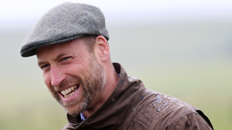 Prince William smiling, wearing a flat cap (2025)