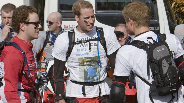 Guy Pelly, Prince William, and Prince Harry prepare to ride their bikes for UNICEF