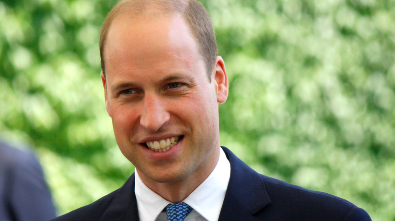 Prince William flashes a grin for the cameras