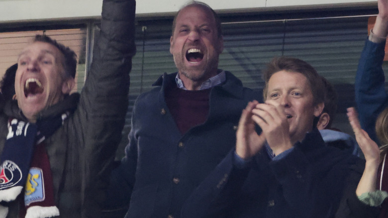 Prince William cheering in crowd of football fans